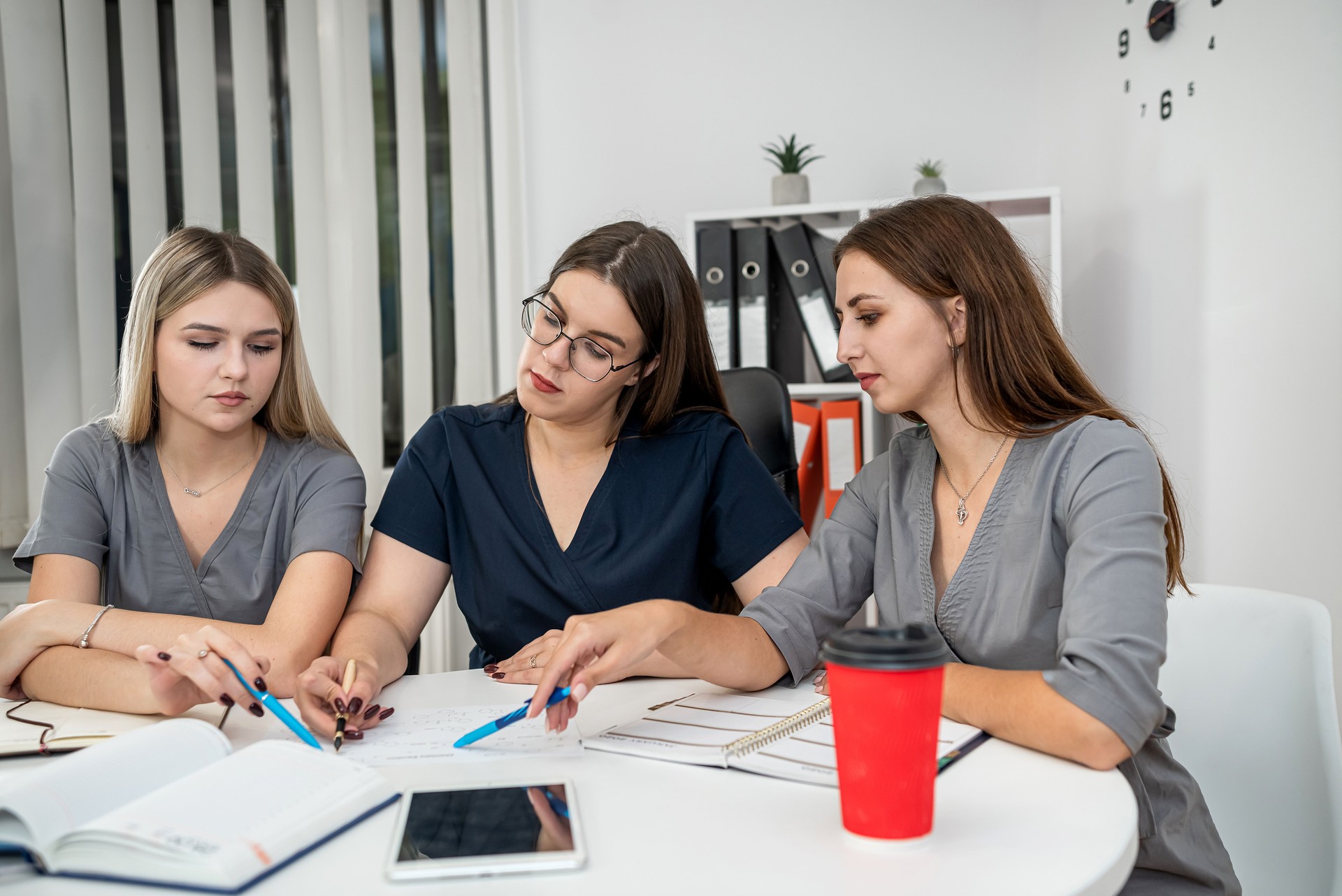 discussion between female scientists in the office, pharmaceutics writing chemical formulas